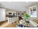 Open concept kitchen with island, modern appliances, and dining area at 24263 E 41St Ave, Aurora, CO 80019