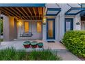Inviting porch with covered swing, stylish entrance, and modern accents at 10305 Martin Luther King Blvd, Denver, CO 80238