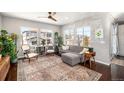 Bright and airy living room with hardwood floors, large windows and comfortable seating at 162 Starlight Cir, Erie, CO 80516