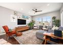 Bright living room with hardwood floors, large windows, and stylish furnishings at 162 Starlight Cir, Erie, CO 80516