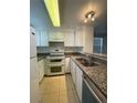 Well-equipped kitchen features white appliances, granite countertops, and tile floors for easy cleanup at 16485 E 17Th Pl # D, Aurora, CO 80011