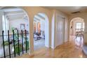 Hallway with arched doorways and hardwood floors at 8561 E Grand Ave, Denver, CO 80237