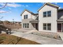 Charming townhome featuring a modern two-tone exterior and well-manicured landscaping at 16798 W 94Th Way, Arvada, CO 80007