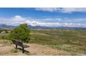 Scenic overlook featuring a wooden bench with a view of the plains and mountains at 3194 W 9Th Avenue Pl, Broomfield, CO 80020
