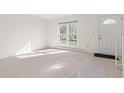 Sunny living room features a large picture window and a white front door at 3194 W 9Th Avenue Pl, Broomfield, CO 80020
