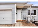 Inviting front porch with seating and a 'Welcome' mat, attached garage, and nice curb appeal at 1010 Emporia St, Aurora, CO 80010