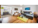 Bright living room featuring hardwood floors, a comfortable sofa, and an open layout at 1010 Emporia St, Aurora, CO 80010