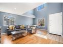 Inviting living room with hardwood floors, abundant natural light, and comfortable seating at 5229 Nighthawk Pkwy, Brighton, CO 80601