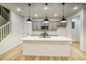 Contemporary kitchen with a large island, stainless appliances, and pendant lighting at 8637 Middle Fork St, Littleton, CO 80125