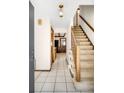 Inviting entryway features tiled floors and a staircase, offering a glimpse into the home's layout at 12579 Appaloosa Pl, Broomfield, CO 80020