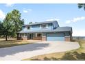 Charming two-story home boasts a well-manicured lawn and a welcoming brick facade at 12579 Appaloosa Pl, Broomfield, CO 80020