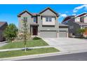 Charming two-story home with a well-maintained lawn and a three-car garage at 12210 Pine Post Dr, Parker, CO 80138