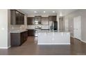 Modern kitchen with dark cabinets, stainless steel appliances, and granite countertops at 12210 Pine Post Dr, Parker, CO 80138