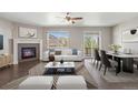 Living room featuring a fireplace, access to the patio, and modern furnishings at 12210 Pine Post Dr, Parker, CO 80138
