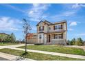 Charming two-story home with stone and tan siding, landscaped yard, and inviting front porch at 22268 E Hidden Trail Dr, Parker, CO 80138