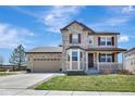 Charming two-story home with a well-maintained lawn, covered porch, and attached two-car garage at 22268 E Hidden Trail Dr, Parker, CO 80138