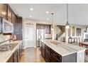 Spacious kitchen with granite counters, stainless appliances, large island, and hardwood flooring at 22268 E Hidden Trail Dr, Parker, CO 80138