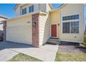 Lovely two-story home featuring a red front door and attached two-car garage at 4965 Collinsville Pl, Highlands Ranch, CO 80130
