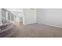 Neutral living room with carpeted floor, stairs, and bright lighting at 4965 Collinsville Pl, Highlands Ranch, CO 80130