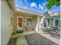 Inviting front entrance with chairs, a decorative storm door and brick accents at 5319 E Davies Dr, Centennial, CO 80122