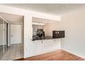 Compact kitchen with dark countertops and microwave at 14110 E Temple Dr # X02, Aurora, CO 80015