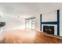 Bright living room with hardwood floors and fireplace at 14110 E Temple Dr # X02, Aurora, CO 80015