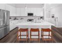 Modern kitchen with stainless steel appliances, white cabinets, a large center island, and stylish pendant lighting at 138 S Seacrest St, Golden, CO 80401