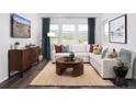Bright and airy living room with hardwood floors, a comfortable sofa, and large windows offering scenic views at 138 S Seacrest St, Golden, CO 80401