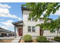 Charming home exterior featuring a modern design, red front door, and lush green bushes at 16019 E Elk Dr, Denver, CO 80239