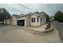 Beautiful home featuring a spacious garage, manicured landscaping, and charming curb appeal at 12235 E 2Nd Dr, Aurora, CO 80011