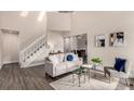 Bright living room features a staircase and a stylish seating arrangement at 3049 E Long S Cir, Centennial, CO 80122