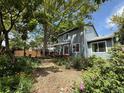 Private backyard featuring a patio area, mature trees, and lush landscaping at 823 Timothy Dr, Longmont, CO 80503