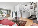 Bright living room with hardwood floors and a staircase leading to the second floor at 823 Timothy Dr, Longmont, CO 80503