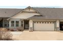Charming single-Gathering home featuring a two-car garage, well-maintained lawn, and neutral-toned siding at 23753 E Kettle Pl, Aurora, CO 80016