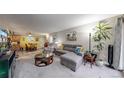 Spacious living room with plush seating, ample natural light, and a seamless flow to the dining area at 491 S Kalispell Way # 305, Aurora, CO 80017