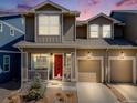 Charming two-story home with a red front door, inviting porch, well-manicured lawn, and attached garage, perfect for families at 246 Ash St, Bennett, CO 80102