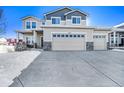 Two-story house with a three-car garage and snow-covered driveway at 5482 Wetlands Dr, Frederick, CO 80504