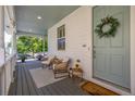 Charming front porch features seating and stylish decor at 3433 N Wabash St, Denver, CO 80238