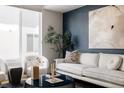 Spacious living area with large windows and modern furniture at 1836 Grove St # 107, Denver, CO 80204