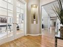 Bright entryway with hardwood floors and French doors leading to an office at 10750 Fairbairn Way, Highlands Ranch, CO 80130