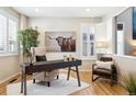 Home office featuring a large desk, comfortable chair, and hardwood floors at 10750 Fairbairn Way, Highlands Ranch, CO 80130