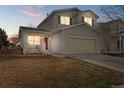 Charming two-story home with a welcoming front porch and well-maintained lawn at 1189 Fall River Cir, Longmont, CO 80504