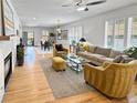 Spacious open-concept living area showcasing a fireplace and hardwood floors at 7722 E 6Th Pl, Denver, CO 80230