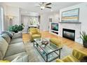 Cozy living room with fireplace, hardwood floors, and bright, airy feel at 7722 E 6Th Pl, Denver, CO 80230