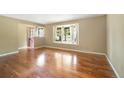 Bright and airy living room featuring hardwood floors, neutral paint, and a large bay window at 10868 W 70Th Ave, Arvada, CO 80004
