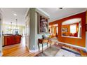 Warm foyer featuring hardwood floors, a decorative table, and views into adjacent living spaces at 2334 Yosemite St, Denver, CO 80238