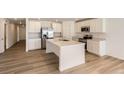 Modern kitchen featuring white cabinets, stainless steel appliances and a large island at 21935 E 39Th Pl, Aurora, CO 80019