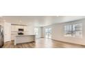 Bright, open-concept living space with wood floors and large windows at 21935 E 39Th Pl, Aurora, CO 80019