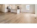 Bright, open-concept living space with wood floors and stainless appliances at 21935 E 39Th Pl, Aurora, CO 80019