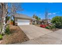 Single story home with an attached garage, and driveway at 18771 Mexico E Dr, Aurora, CO 80017